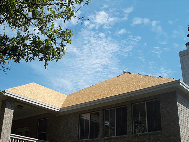 Roof with asphalt shingles that are need of repair.