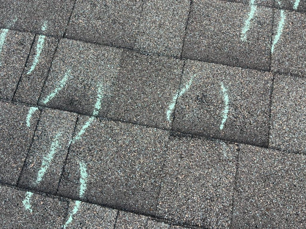 Chalk tally marks counted across one asphalt shingle test area on a Schertz, Texas roof