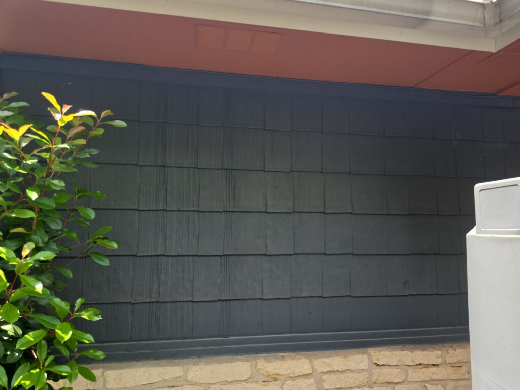 Shingle-style siding above a limestone base on an Austin home