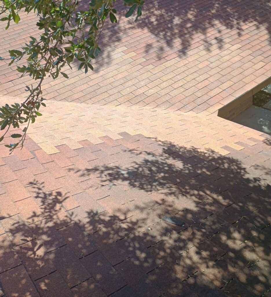 Finished roof valley repair, with the new shingles visibly lighter than the weathered shingles around them